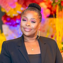 Chandra Gordon, a dark-skinned woman in a black suit and hair styled in a bun