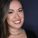 Nicole Crump, a woman with light brown hair against a dark blue background