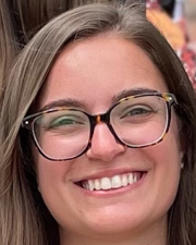 Janie Claywell, KUCDD Associate Researcher: A woman with light brown hair and thick-square rimmed glasses 