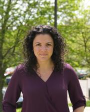 Lindsay Rentschler, a woman with long, curly, dark brown hair